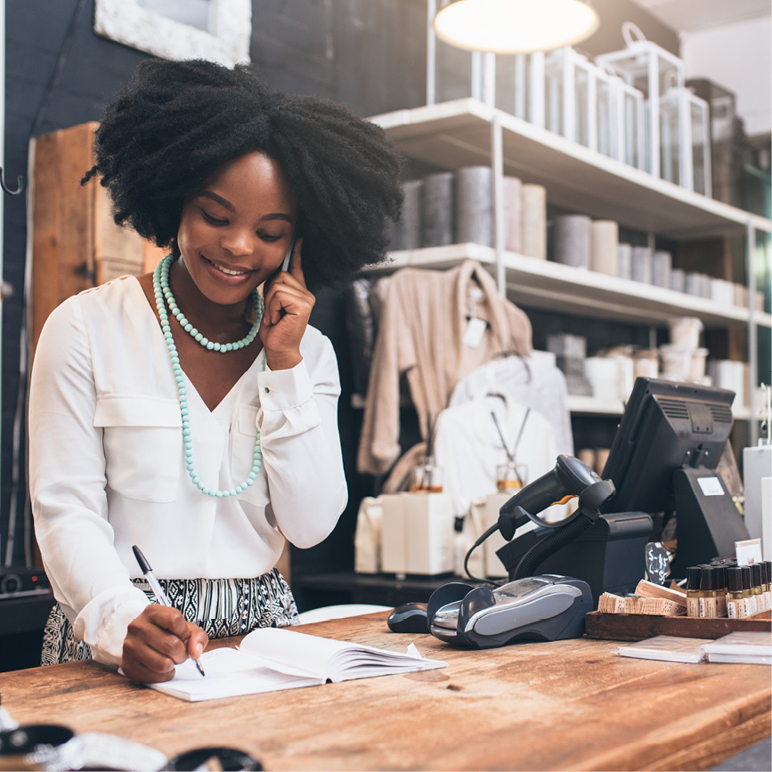 HOPE member of small business on the phone with her customer.