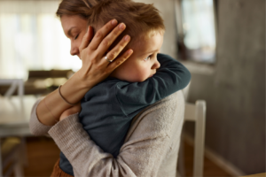 Mother holding child worried and in crisis within the Deep South.